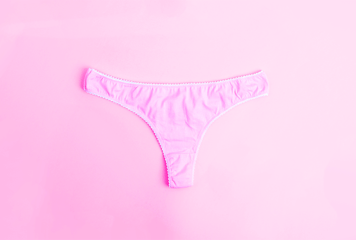 Pink panties on a pink background with red droplets.