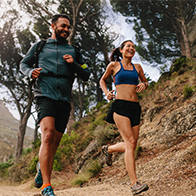 A-man-and-a-woman-running-on-an-outdoor-mountain-trail