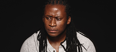A man stares off to the side looking concerned and in thought.