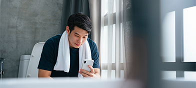 A-man-sits-on-the-toilet-looking-at-his-phone
