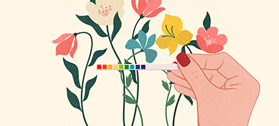 A-hand-holds-up-a-vaginal-ph-scale-against-flowers