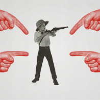 A-surprised-boy-holds-a-gun-while-fingers-point-at-him