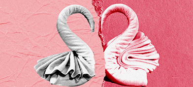Two towels formed into half a heart break apart against a multi-shaded pink background.
