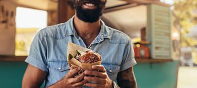 A-bearded-man-holds-a-burger