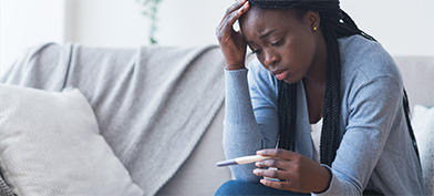 A-distraught-woman-looks-at-a-pregnancy-test