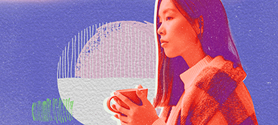 A woman holds a mug between her hands with a blanket around her shoulders against a purple background.