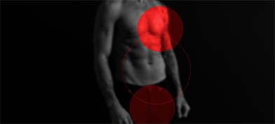 A bright red circle sits over a man's heart while a darker red circle sits over his groin.