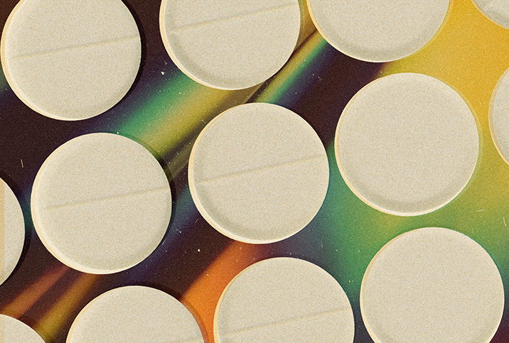Multiple white opioid pills repeat over a holographic background.