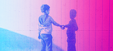 A little boy reaches out to touch his shadow on a pink wall. 
