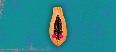 Half of a papaya is against a teal background with two red dots along either side of the open center.