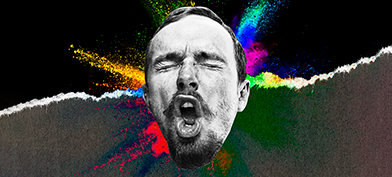 A man makes a face during an orgasm with multiple colors spraying from behind his head.