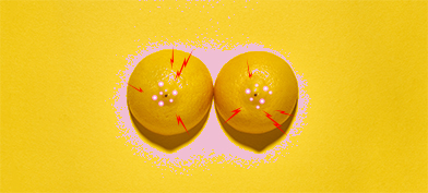 Two lemons, with their pointed sides up, have pink dots and red lightning around the centers. 