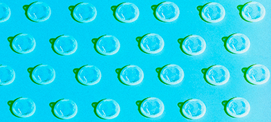 A pattern of white condoms repeat against a blue background.
