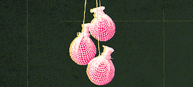 Three pink yoni pearls dangle together against a textured dark green background.