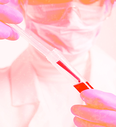 A clear dropper is adding blood to a clear plastic test tube.