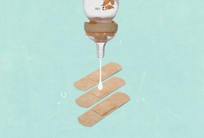 A bottle is upside down dropping breast milk onto a bandaid.
