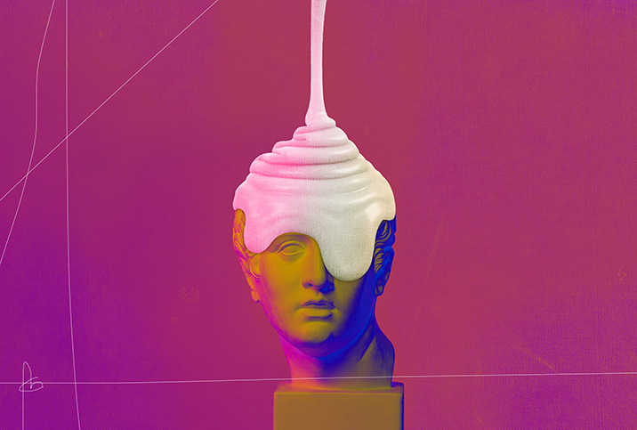 White cream falls down over the top of a roman statue head.