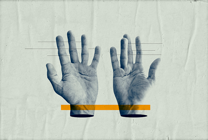 A pair of hands lay open-palmed with a yellow block layering over both wrists.