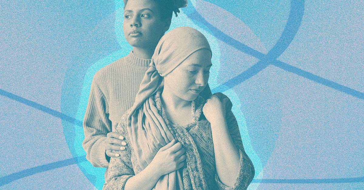A woman holds the shoulder of another woman in a head wrap. 
