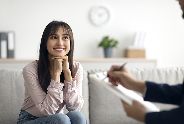 A woman looks lovingly at her therapist.
