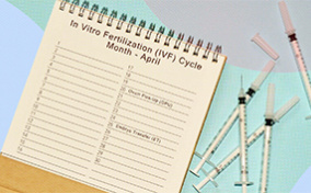 A notepad and medical needles are scattered on a colorful background.