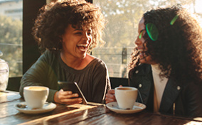 Two-women-laugh-over-coffee