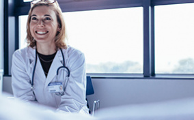 A doctor trained in trauma-informed care talks to a patient.