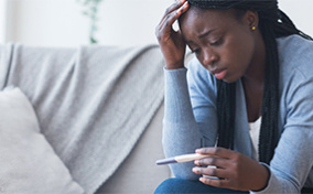 A-distraught-woman-looks-at-a-pregnancy-test