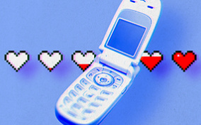 An old flip cellphone is open with a line of white hearts behind it that are filling up with red.